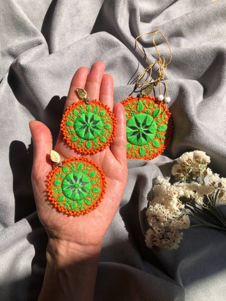 Handmade Embroidered Circular Earrings With Greean And Orange Thread