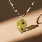 Handmade necklace with real fall leaf pendant and natural Mookaite gemstone beads, autumn-inspired jewelry design