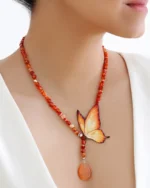 Handmade butterfly jewelry set with orange wing necklace and matching earrings, designed with natural carnelian gemstone beads and teardrop pendant