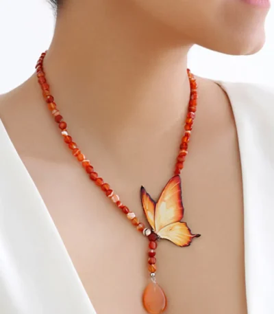 Handmade butterfly jewelry set with orange wing necklace and matching earrings, designed with natural carnelian gemstone beads and teardrop pendant