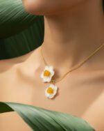 Natural daffodil flower necklace with UV resin coating on a gold chain, worn on model’s neck