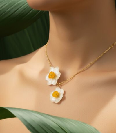 Natural daffodil flower necklace with UV resin coating on a gold chain, worn on model’s neck