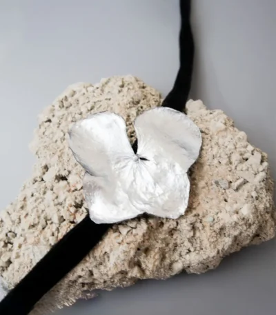 Handmade choker featuring a real hydrangea flower coated with silver leaf and UV resin, set on a black velvet band