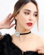 Model wearing a handmade choker necklace with a real hydrangea flower coated in silver leaf and UV resin, set on a black velvet band