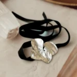Handmade choker featuring a real hydrangea flower coated with silver leaf and UV resin, set on a black velvet band