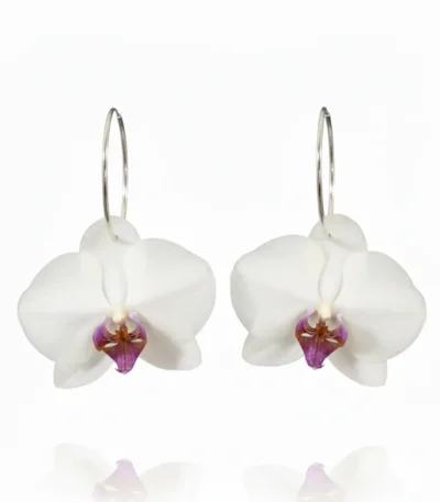 Handmade white orchid hoop earrings with natural preserved petals and silver hoops on a white background
