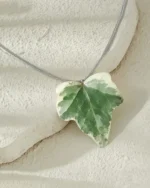 Handmade ivy leaf necklace with silver lame cord and stainless steel clasp on stone