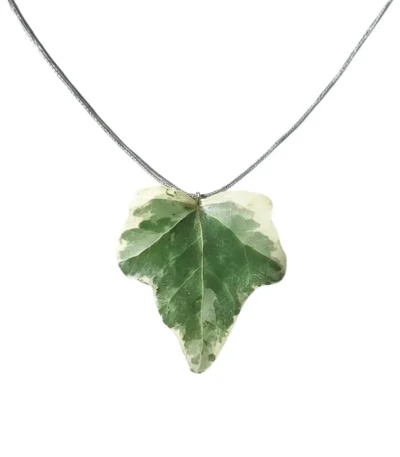 Handmade ivy leaf necklace with silver lame cord and stainless steel clasp on neutral background