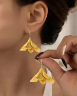 Handmade Dendrobium Orchid Bud Earrings On Model