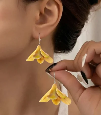 Handmade Dendrobium Orchid Bud Earrings On Model